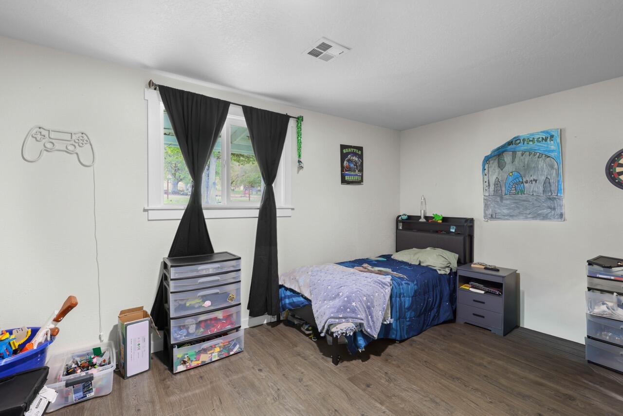 380 Greenleaf Drive Eagle Point, OR 97524 - Photo 25 of 31 a bedroom with furniture and wooden floor