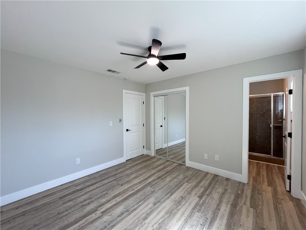 13004 Chestnut Avenue Rancho Cucamonga, CA 91739 - Photo 12 of 28 a view of a room with wooden floor and a ceiling fan
