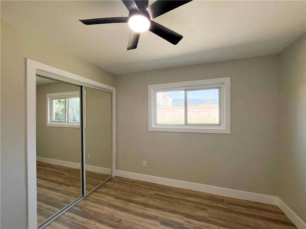 13004 Chestnut Avenue Rancho Cucamonga, CA 91739 - Photo 20 of 28 a view of an empty room with wooden floor and a window