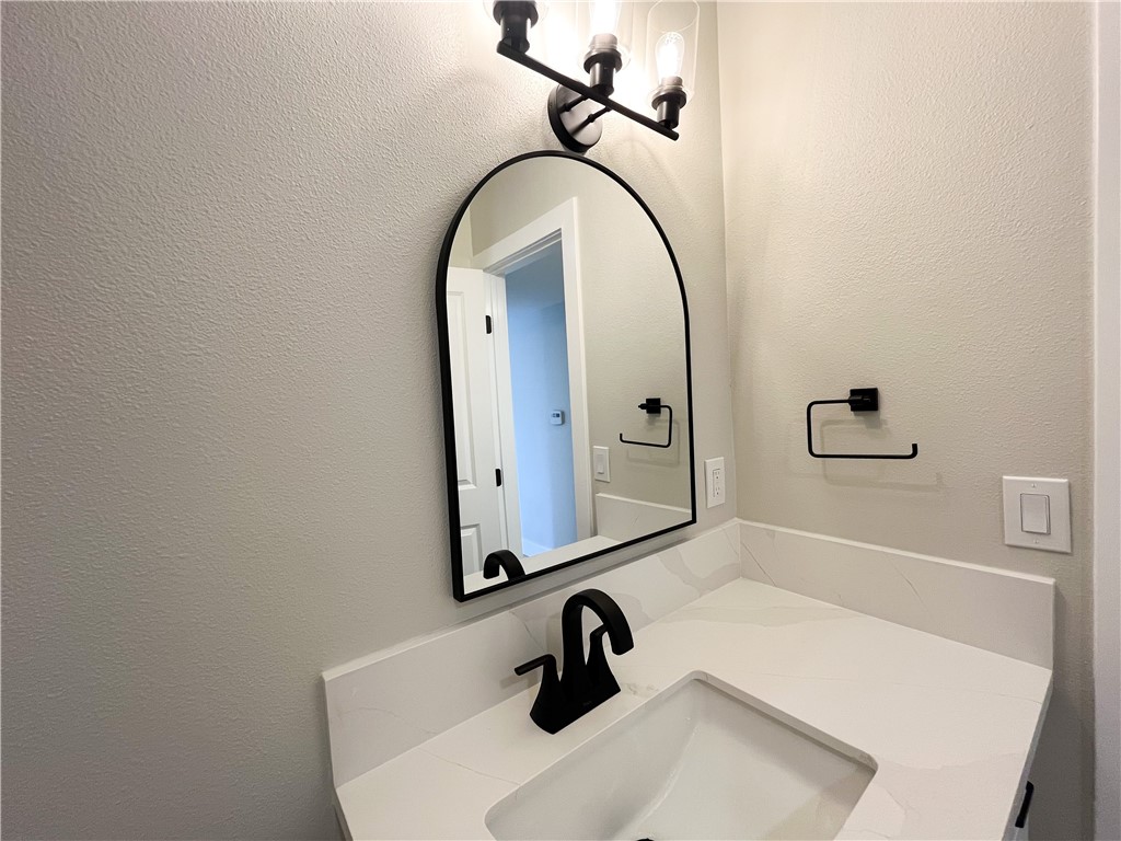 13004 Chestnut Avenue Rancho Cucamonga, CA 91739 - Photo 22 of 28 a bathroom with a sink a toilet and a mirror
