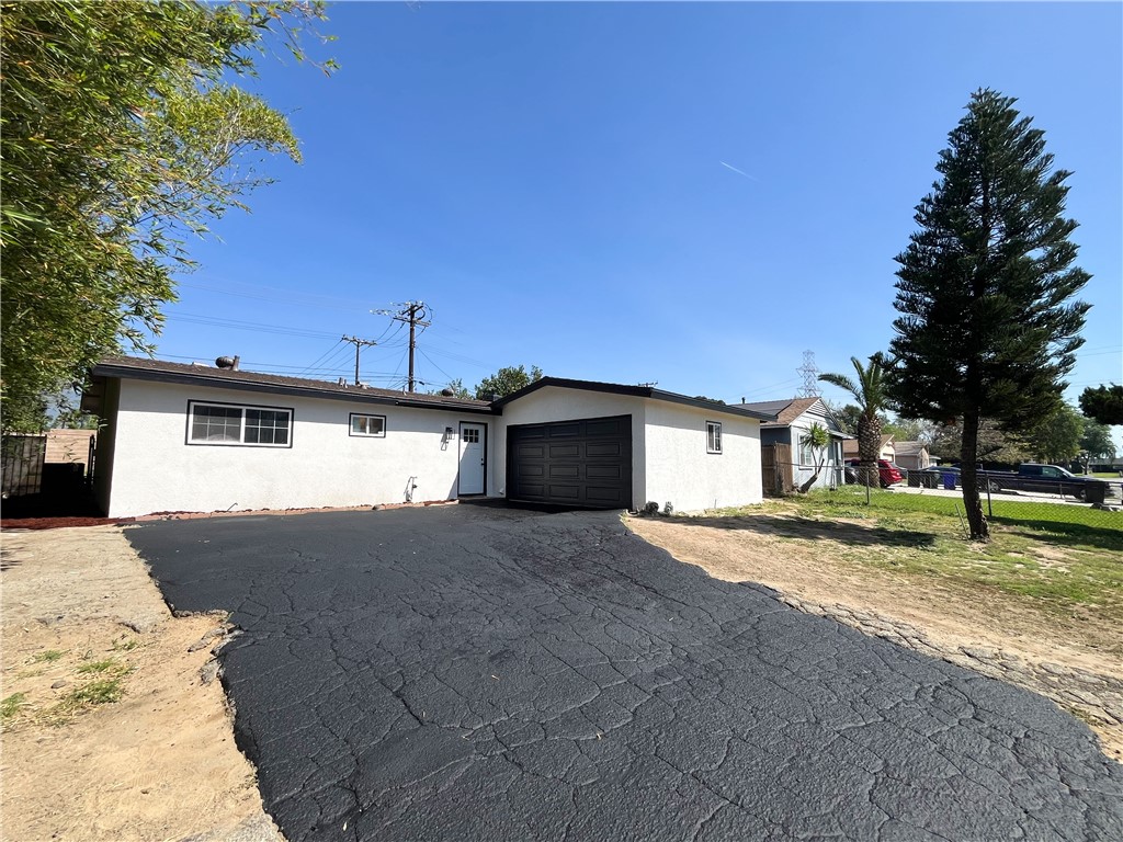 13004 Chestnut Avenue Rancho Cucamonga, CA 91739 - Photo 28 of 28 a front view of a house with a yard and garage