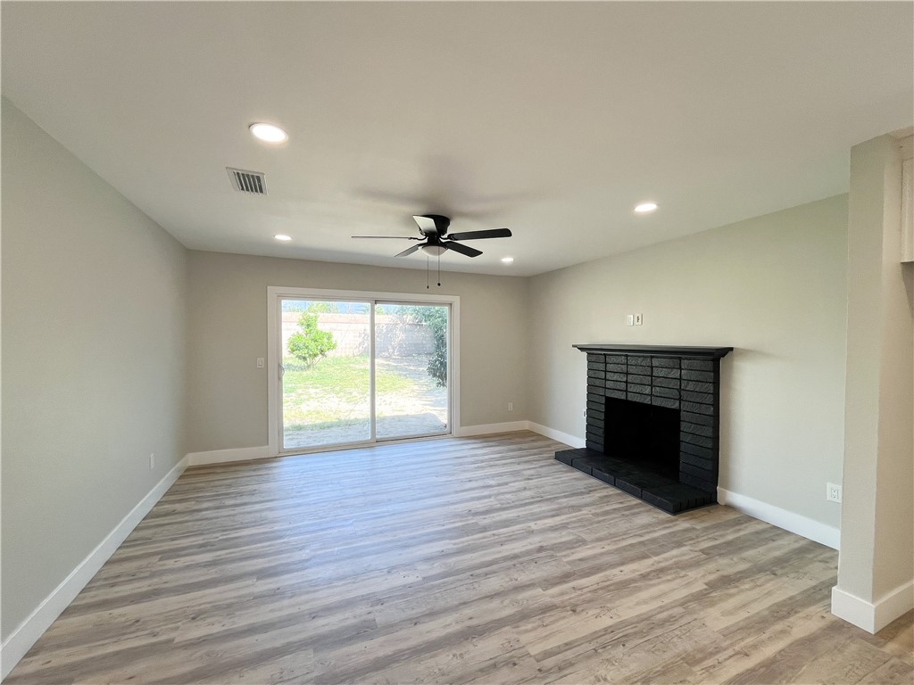 13004 Chestnut Avenue Rancho Cucamonga, CA 91739 - Photo 3 of 28 a view of an empty room with a fireplace and a window