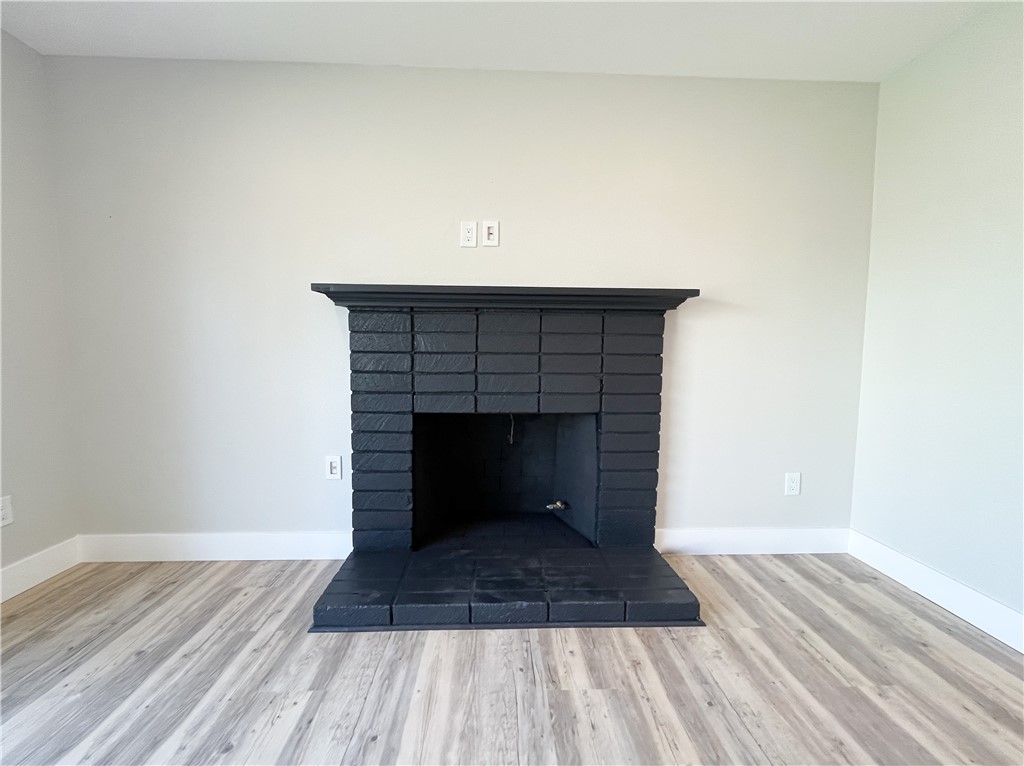 13004 Chestnut Avenue Rancho Cucamonga, CA 91739 - Photo 4 of 28 a view of a livingroom with wooden floor and a fireplace