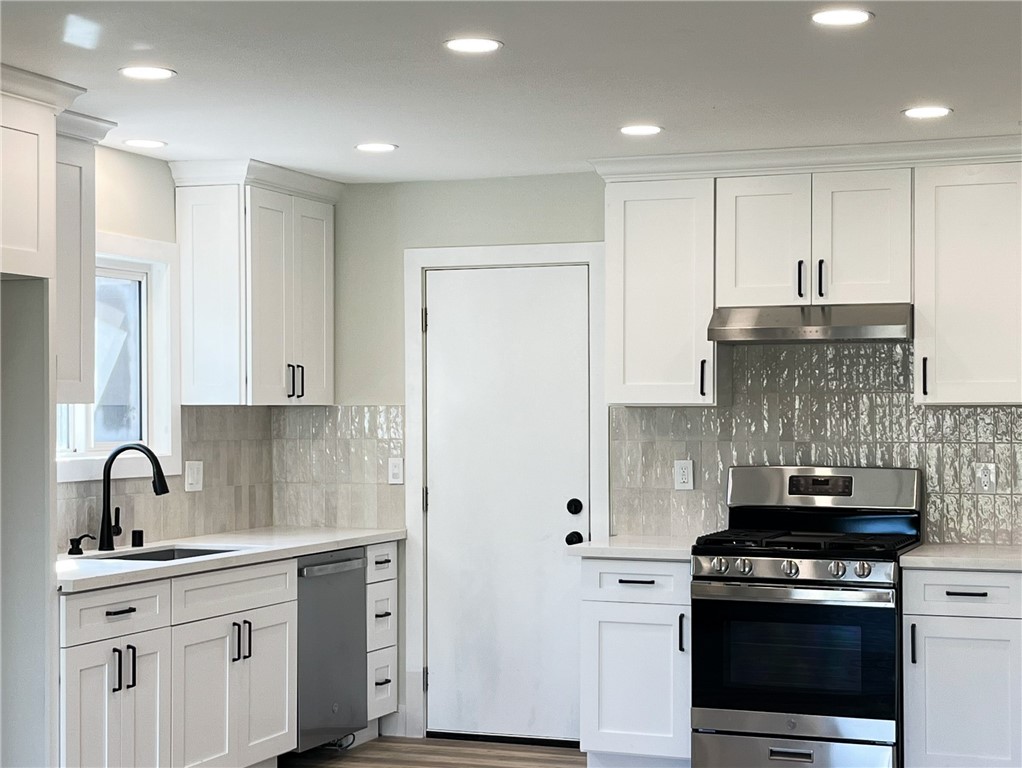 13004 Chestnut Avenue Rancho Cucamonga, CA 91739 - Photo 6 of 28 a kitchen with a stove and a sink