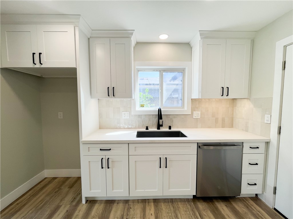 13004 Chestnut Avenue Rancho Cucamonga, CA 91739 - Photo 8 of 28 a kitchen with white cabinets and sink