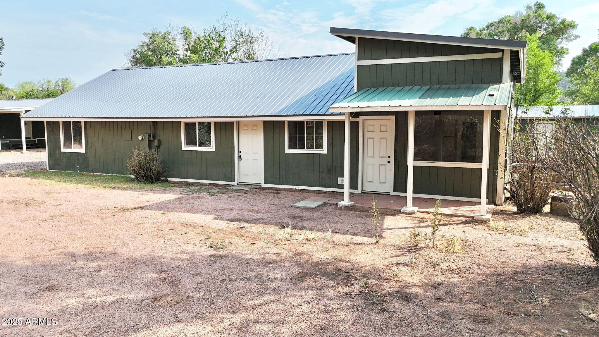 647 South Moonlight Drive Payson, AZ 85541 - Photo 1 of 50 a front view of a house with a yard and garage