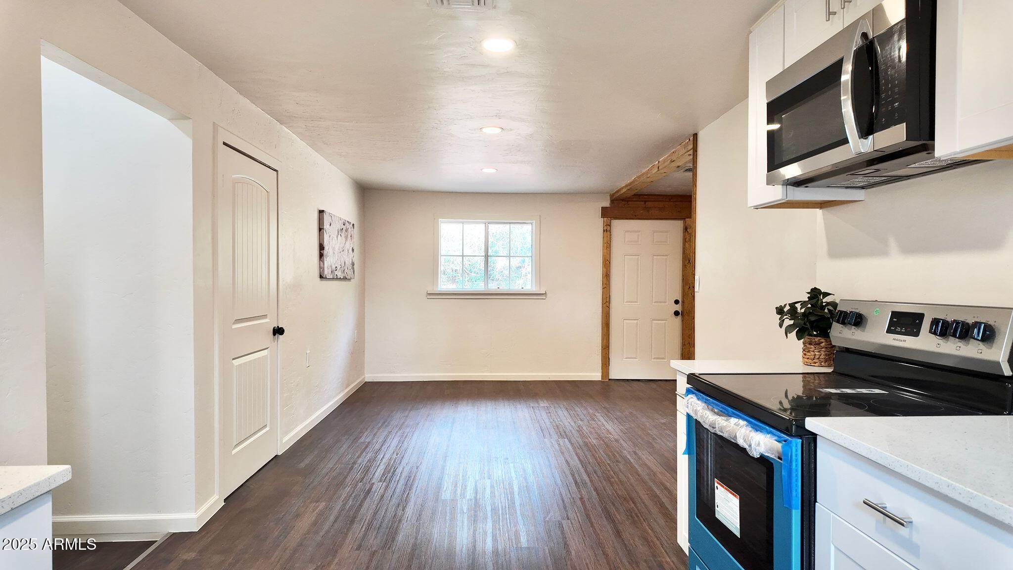 647 South Moonlight Drive Payson, AZ 85541 - Photo 19 of 50 a kitchen with stainless steel appliances granite countertop a stove and a wooden floors
