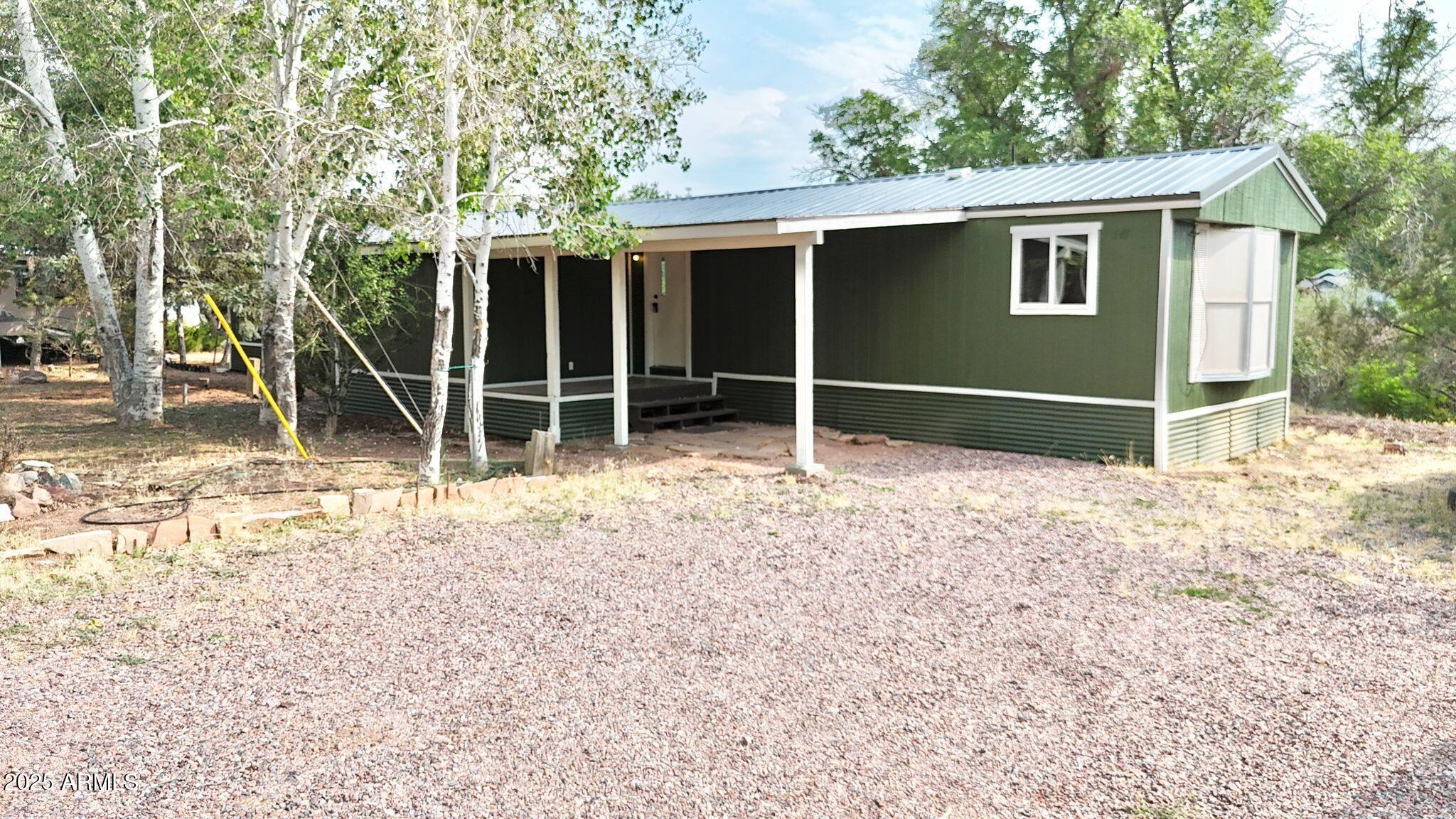 647 South Moonlight Drive Payson, AZ 85541 - Photo 2 of 50 a house with trees in the background