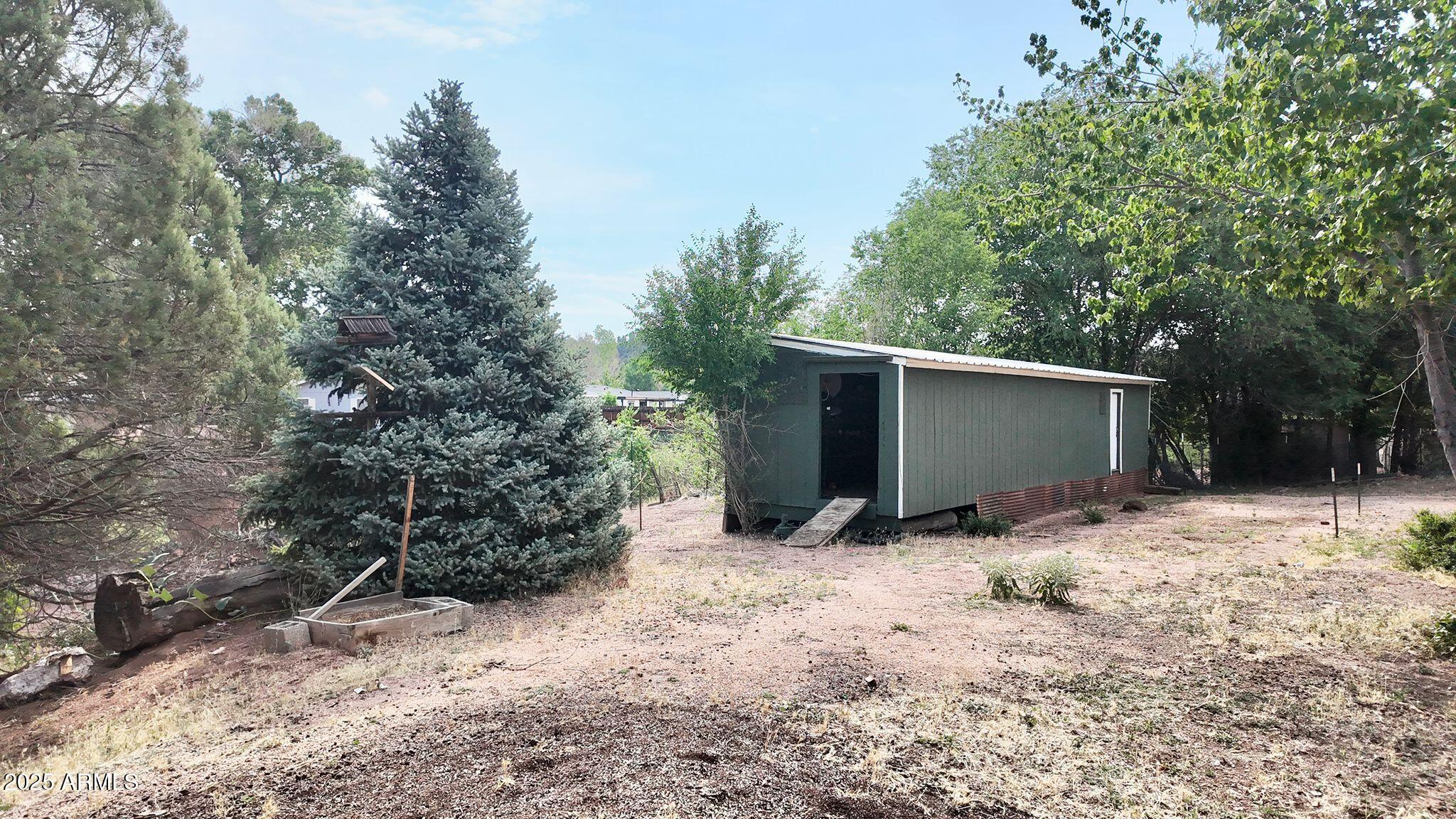 647 South Moonlight Drive Payson, AZ 85541 - Photo 23 of 50 a view of house with trees in the background