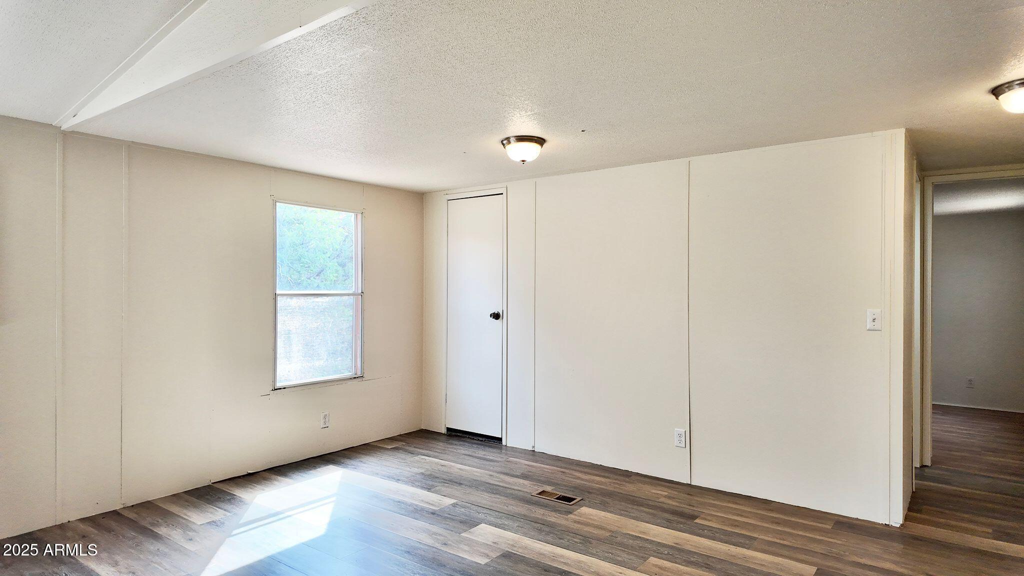 647 South Moonlight Drive Payson, AZ 85541 - Photo 31 of 50 a view of an empty room with wooden floor and a window