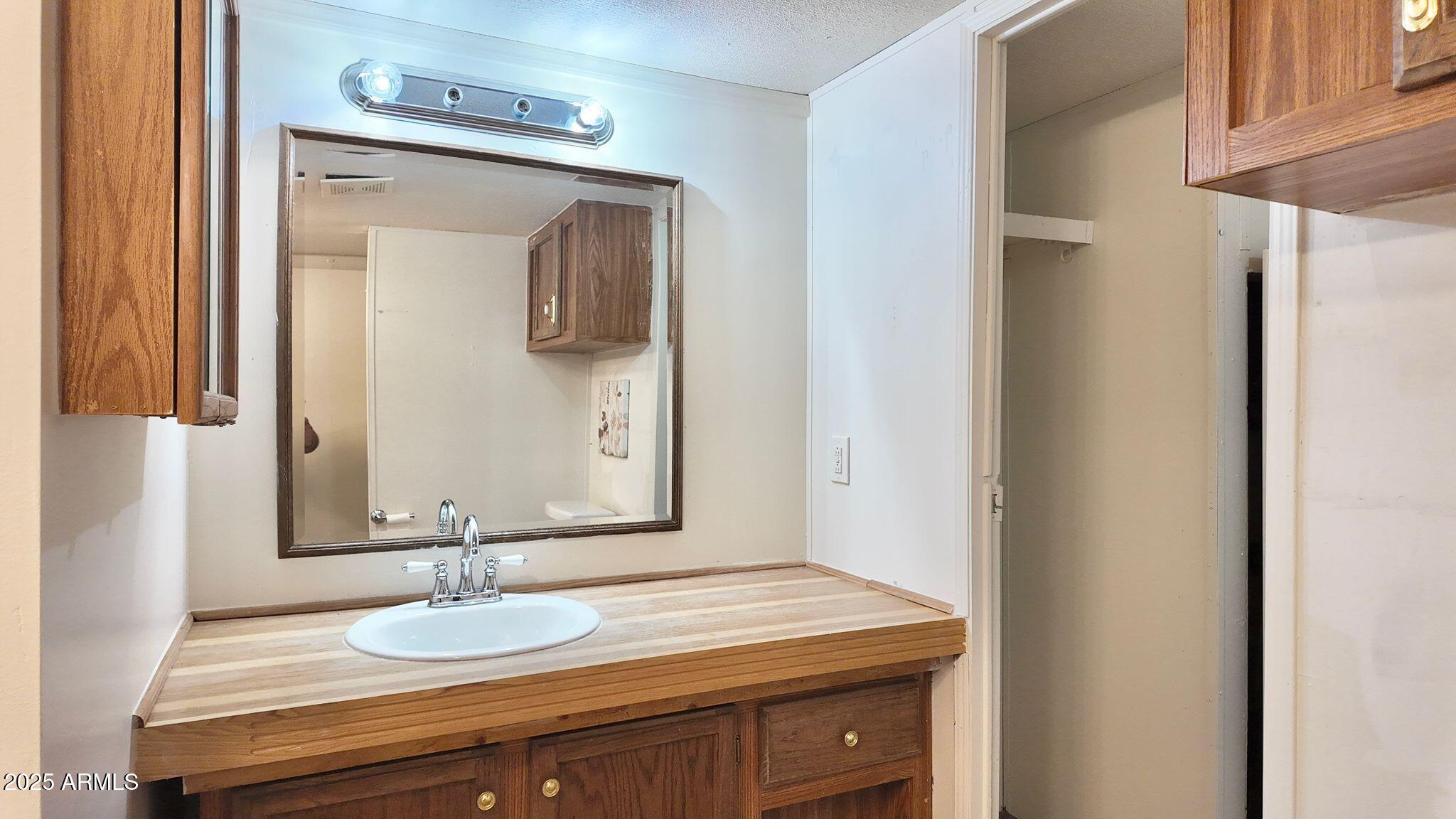 647 South Moonlight Drive Payson, AZ 85541 - Photo 33 of 50 a bathroom with a granite countertop sink and a mirror