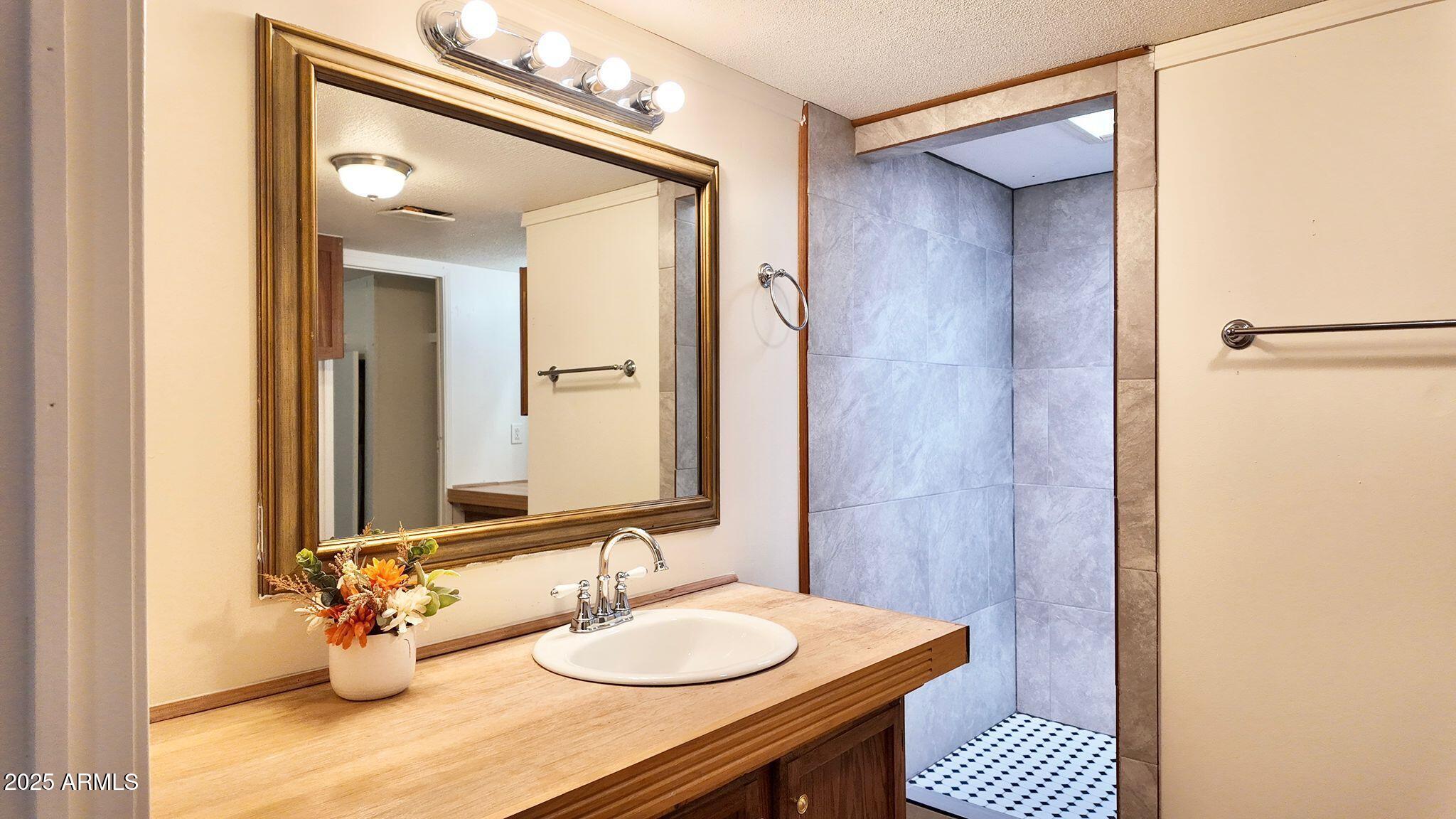 647 South Moonlight Drive Payson, AZ 85541 - Photo 35 of 50 a bathroom with a granite countertop sink and a mirror
