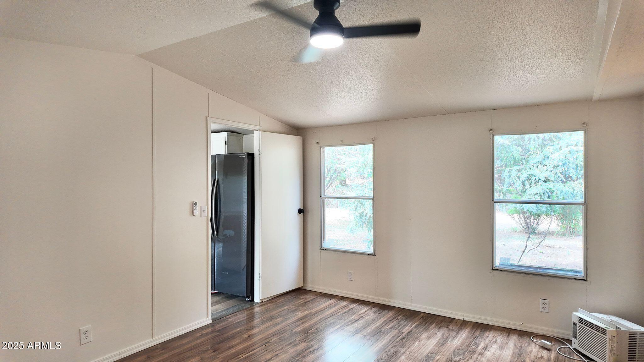 647 South Moonlight Drive Payson, AZ 85541 - Photo 36 of 50 a view of an empty room with wooden floor and a window