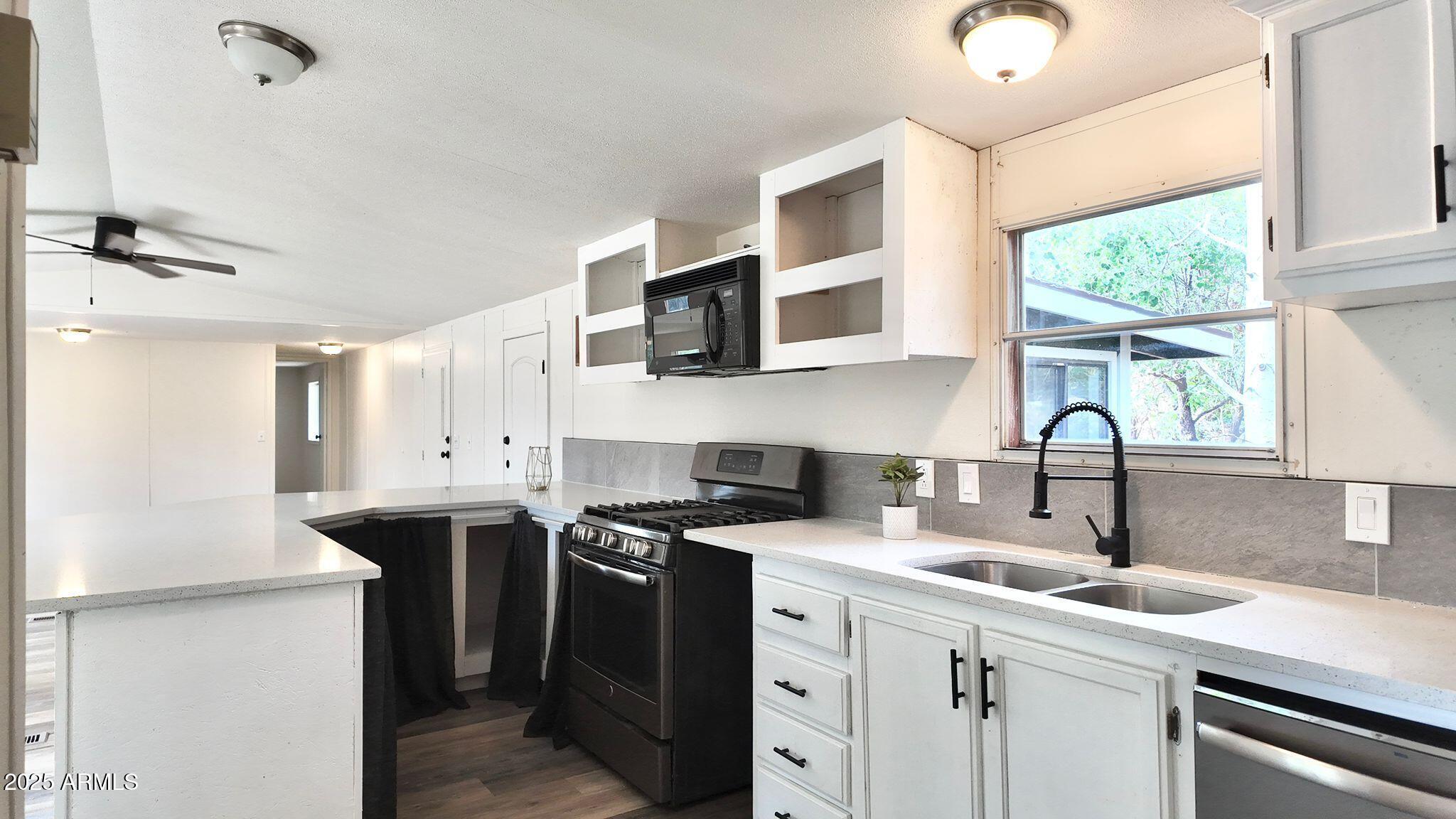 647 South Moonlight Drive Payson, AZ 85541 - Photo 39 of 50 a kitchen with stainless steel appliances white cabinets a sink and a stove