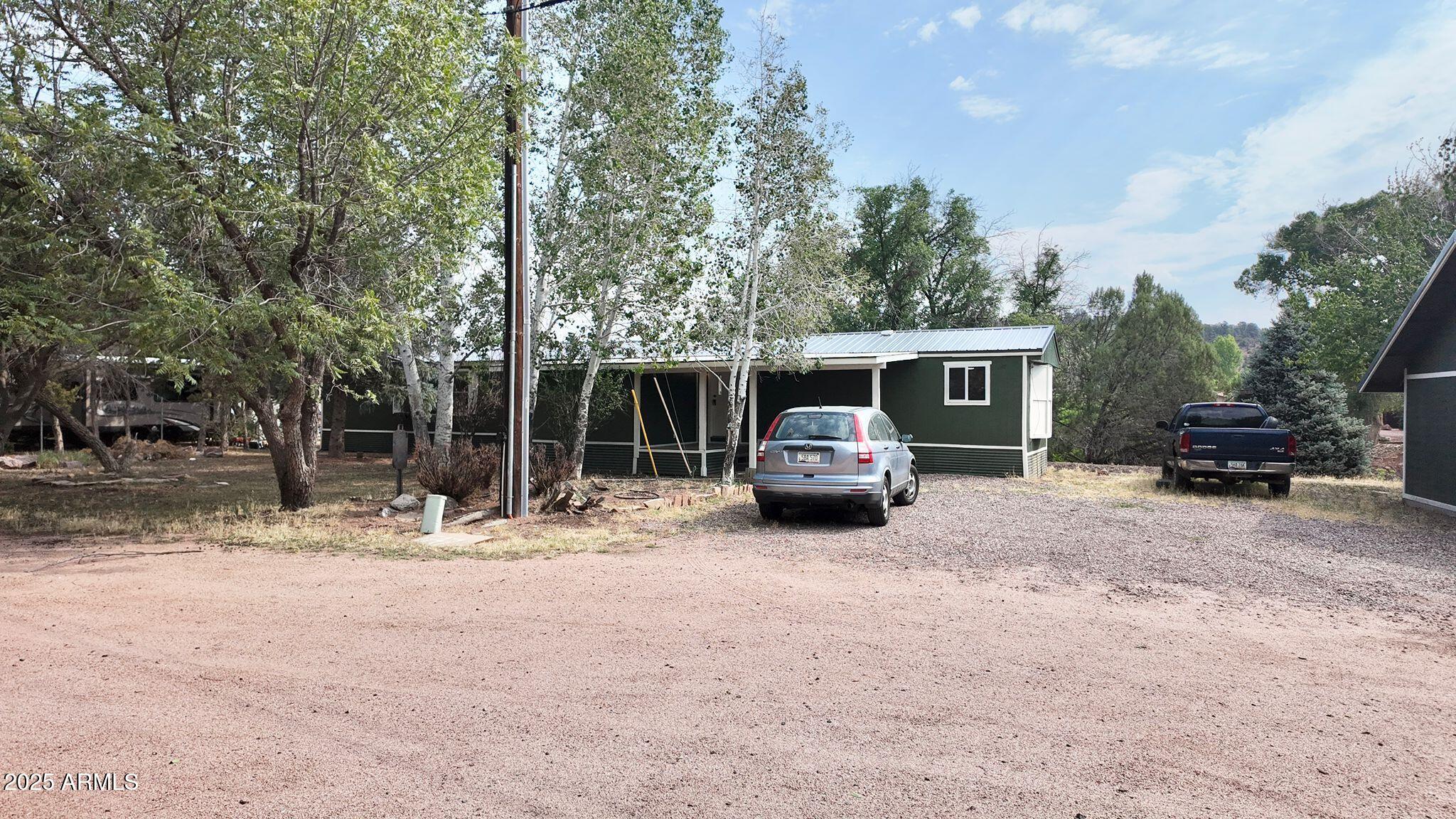 647 South Moonlight Drive Payson, AZ 85541 - Photo 45 of 50 a white house with a large tree in front of it