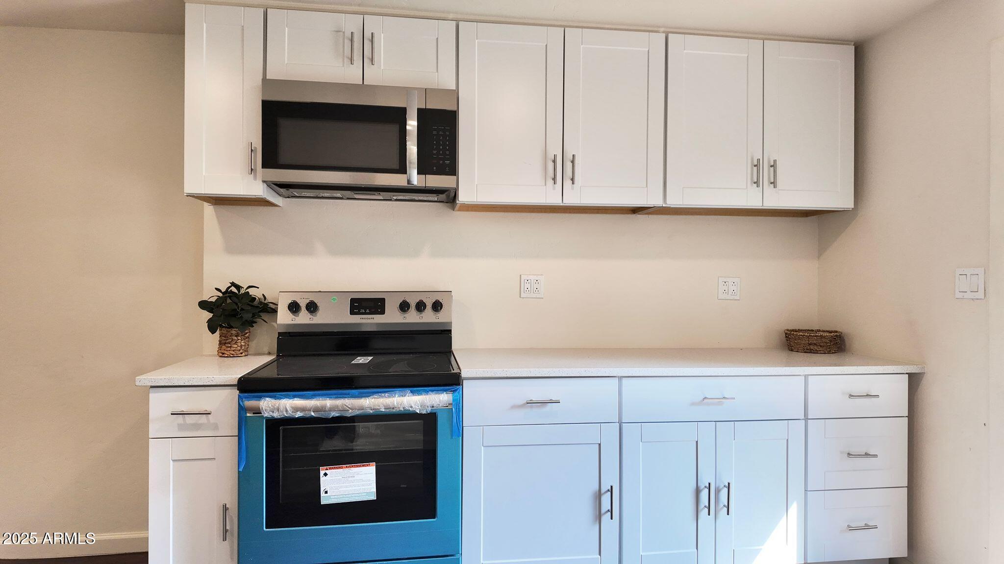 647 South Moonlight Drive Payson, AZ 85541 - Photo 6 of 50 a kitchen with white cabinets stainless steel appliances and a sink
