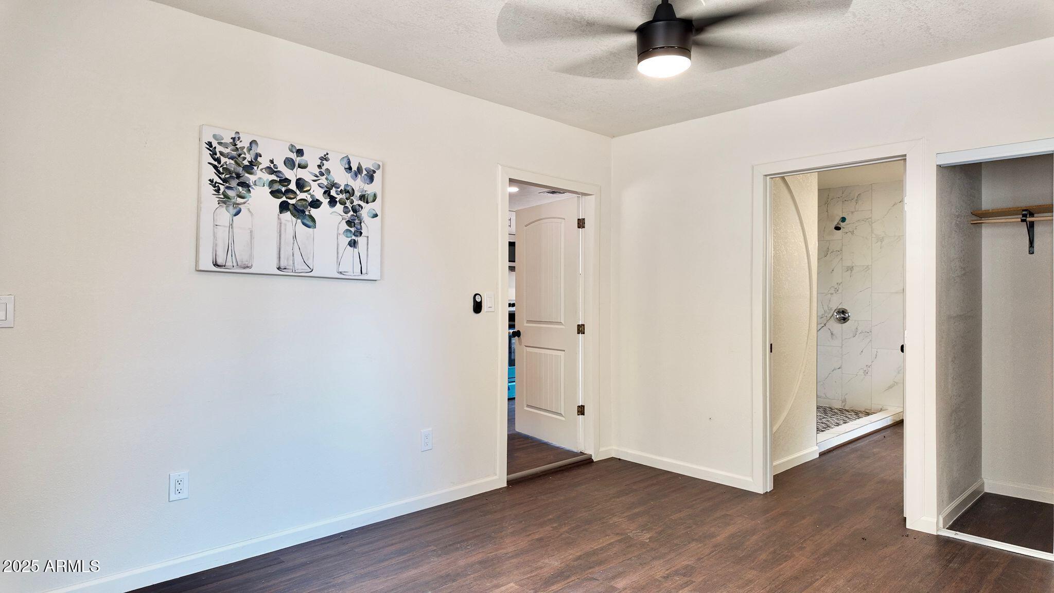 647 South Moonlight Drive Payson, AZ 85541 - Photo 9 of 50 an empty room with wooden floor and ceiling fan