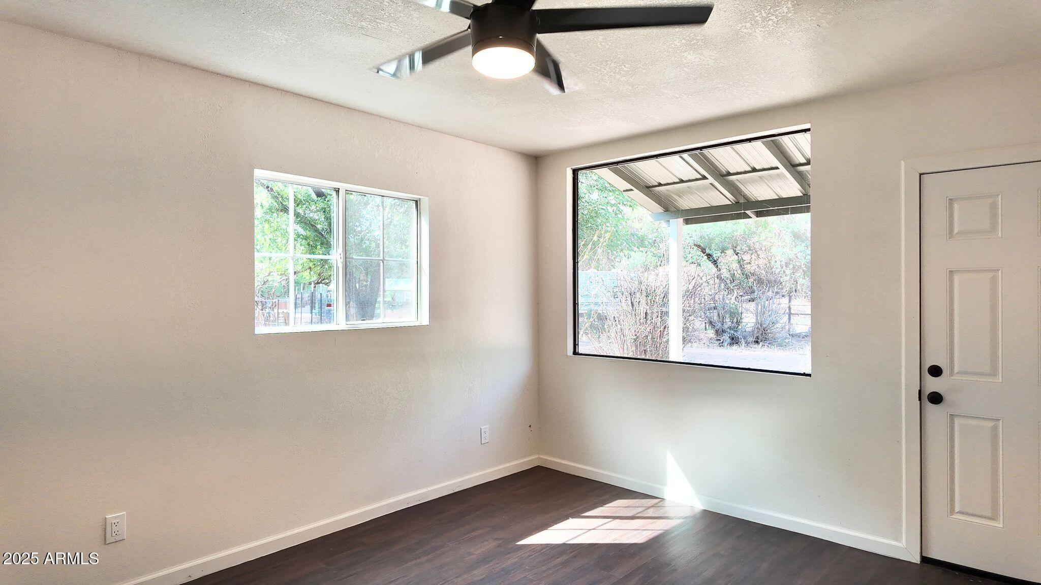 647 South Moonlight Drive Payson, AZ 85541 - Photo 10 of 50 a view of empty room with wooden floor and fan