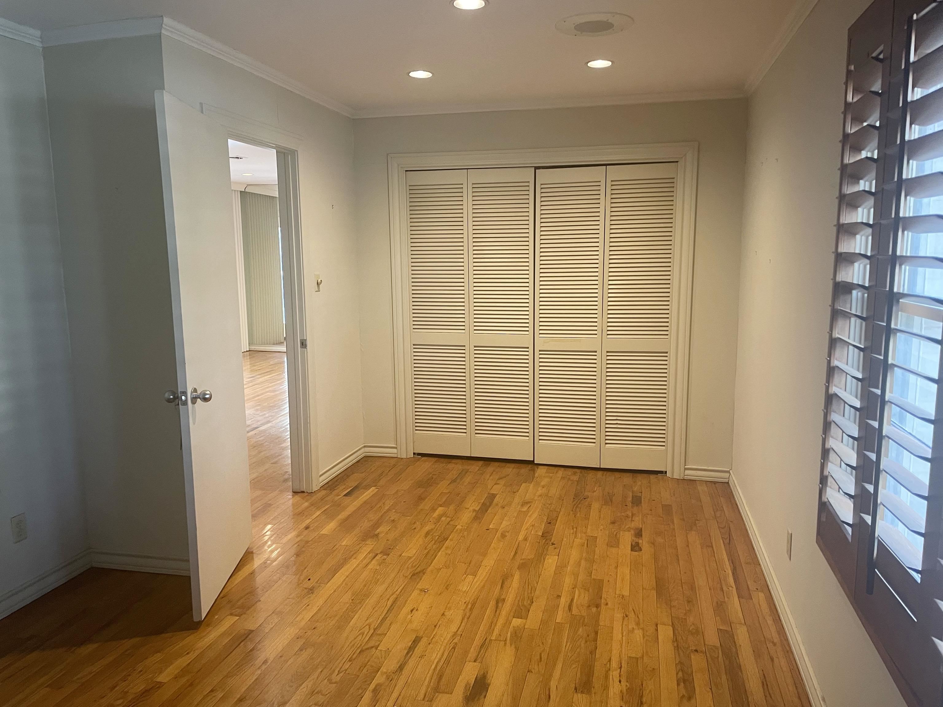 1801 West Commerce Street San Saba, TX 76877 - Photo 18 of 29 a view of an empty room with wooden floor and a window