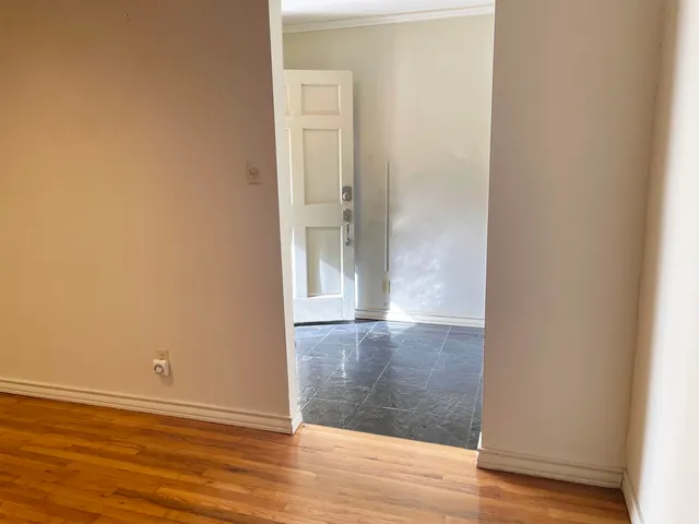 an empty room with wooden floor