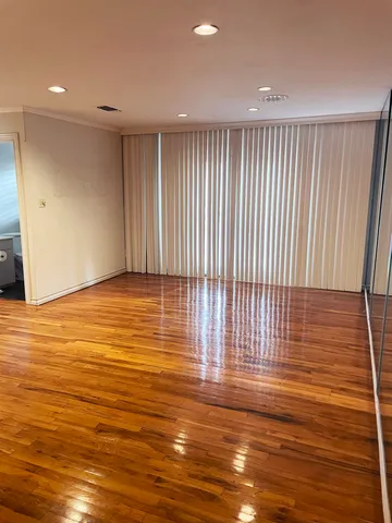 a view of a room with wooden floor and entryway