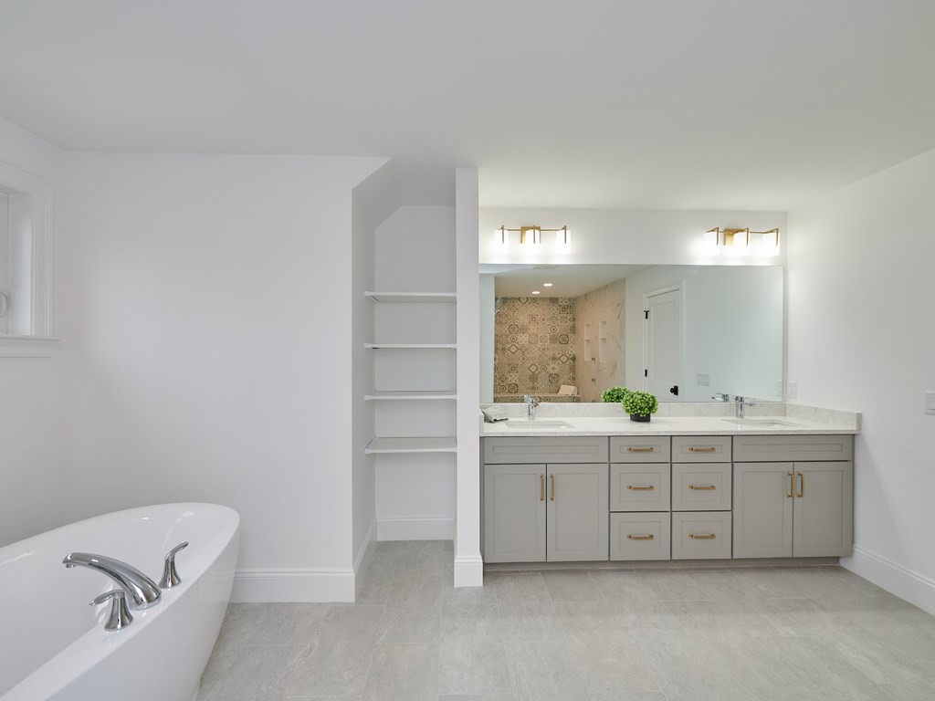 26 Old Colony Road Arlington, MA 02474 - Photo 15 of 32 a bathroom with a bathtub sink and mirror
