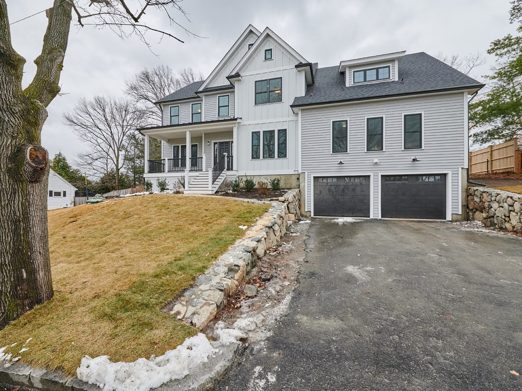 26 Old Colony Road Arlington, MA 02474 - Photo 2 of 32 a front view of a house with a yard and garage