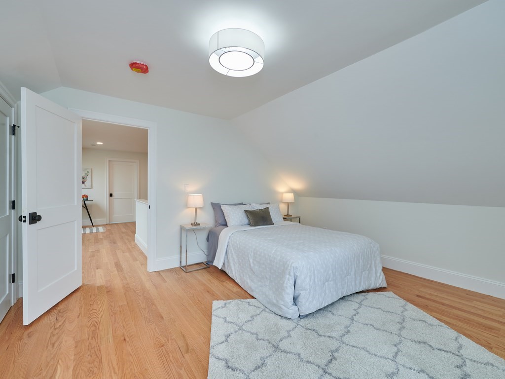 26 Old Colony Road Arlington, MA 02474 - Photo 23 of 32 a bedroom with a bed and a chandelier