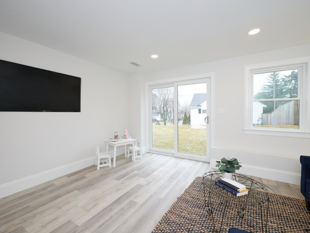 26 Old Colony Road Arlington, MA 02474 - Photo 25 of 32 a living room with furniture and a flat screen tv