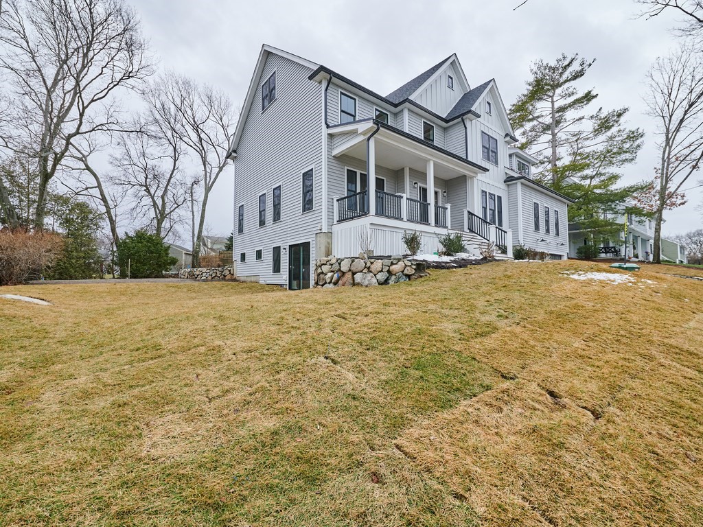 26 Old Colony Road Arlington, MA 02474 - Photo 3 of 32 a view of a white house with a yard covered in snow