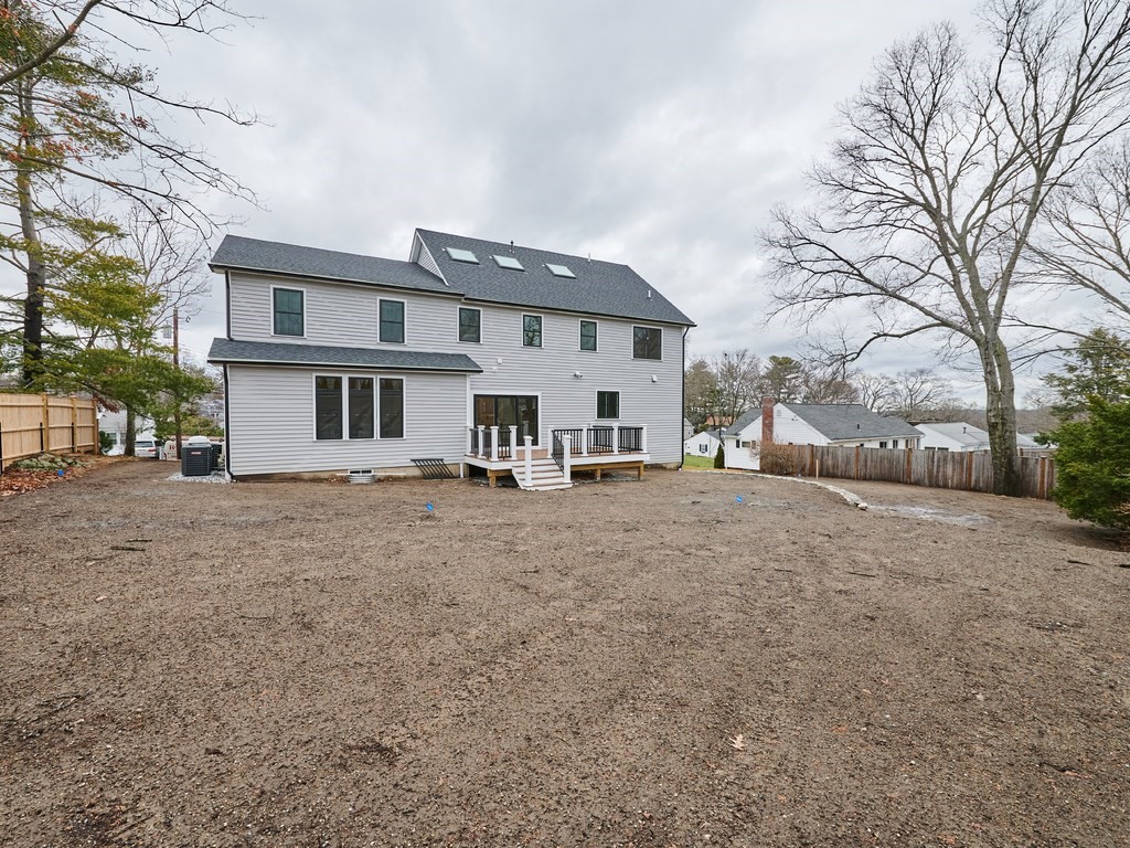 26 Old Colony Road Arlington, MA 02474 - Photo 4 of 32 a view of a house with a large tree in front of it
