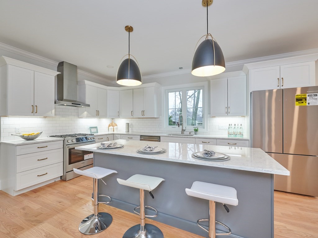 26 Old Colony Road Arlington, MA 02474 - Photo 10 of 32 a kitchen with stainless steel appliances a stove a sink island and a refrigerator