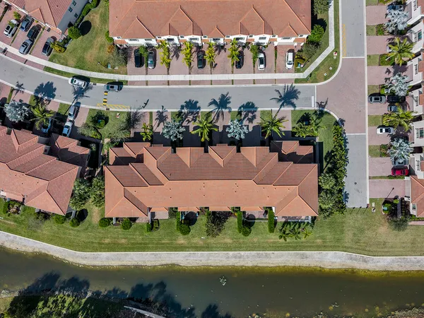 an aerial view of a house with a garden and swimming pool