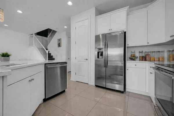 a kitchen with cabinets and stainless steel appliances