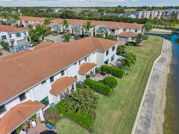 an aerial view of residential houses with outdoor space and river