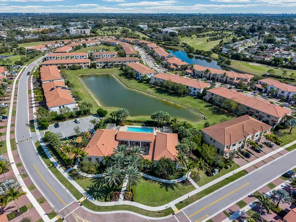 an aerial view of residential houses with outdoor space and river