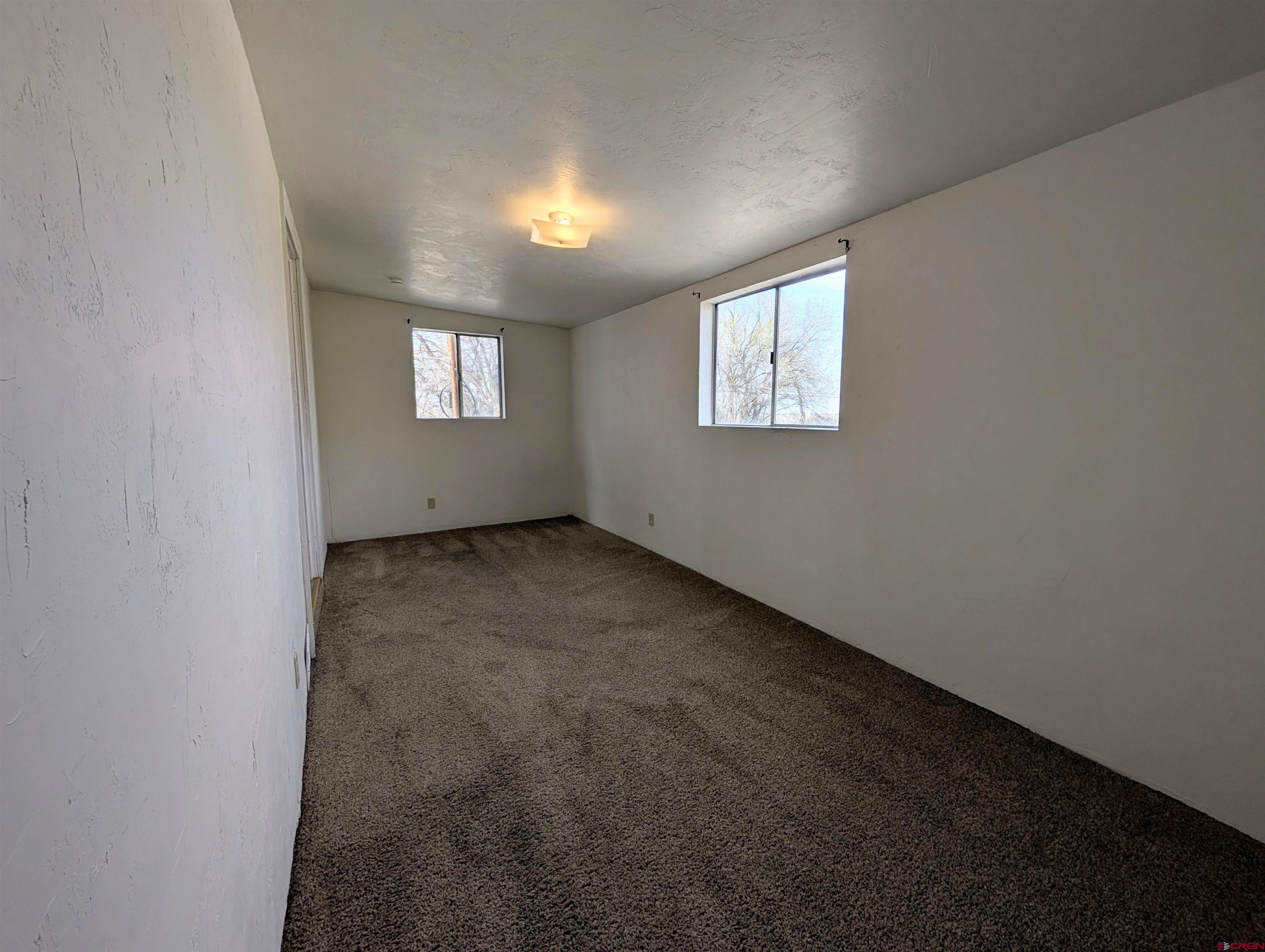 16184 Chipeta Road Montrose, CO 81403 - Photo 13 of 24 an empty room with a empty space and windows