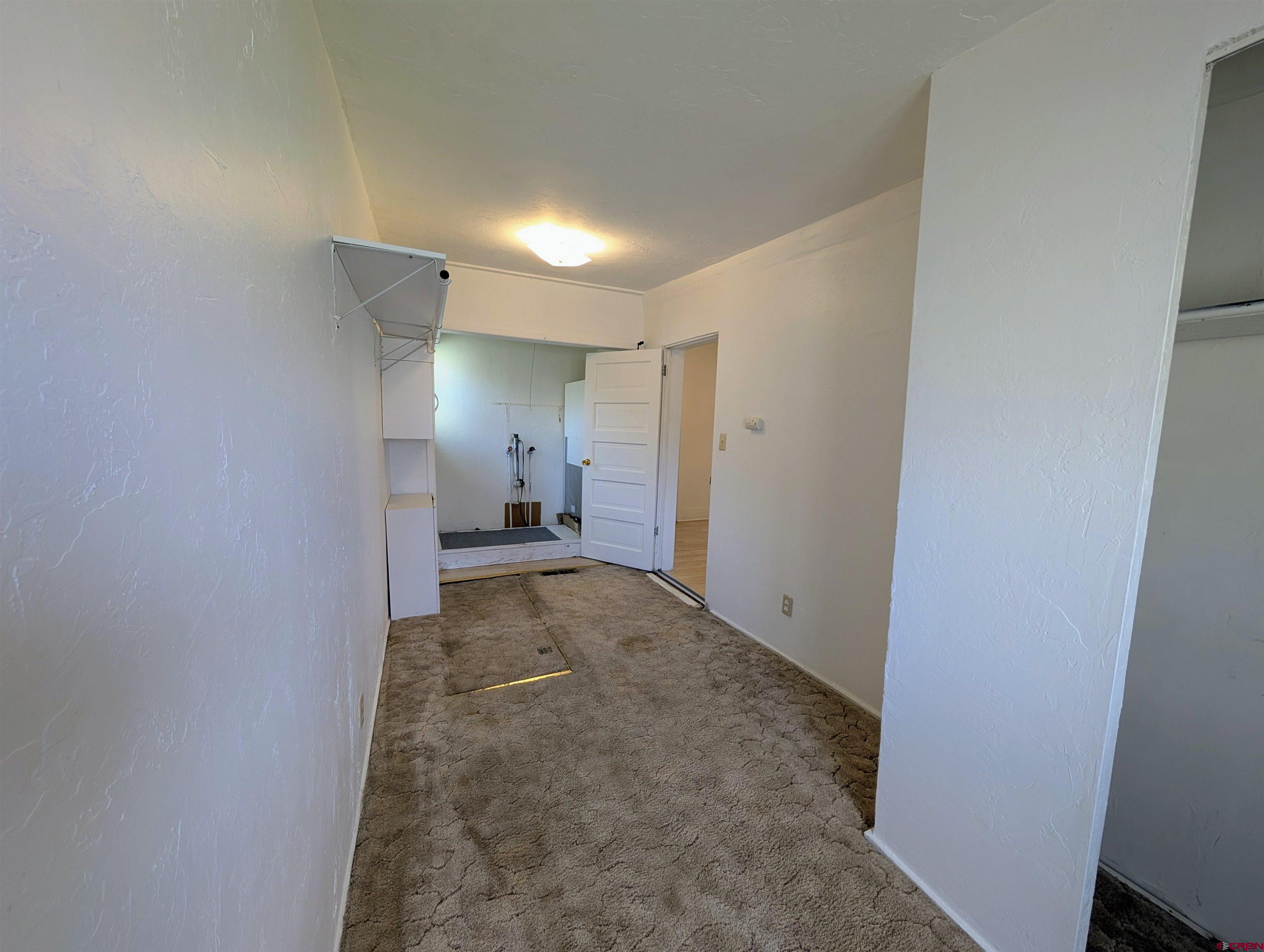16184 Chipeta Road Montrose, CO 81403 - Photo 15 of 24 a view of a big room with wooden floor and a bathroom