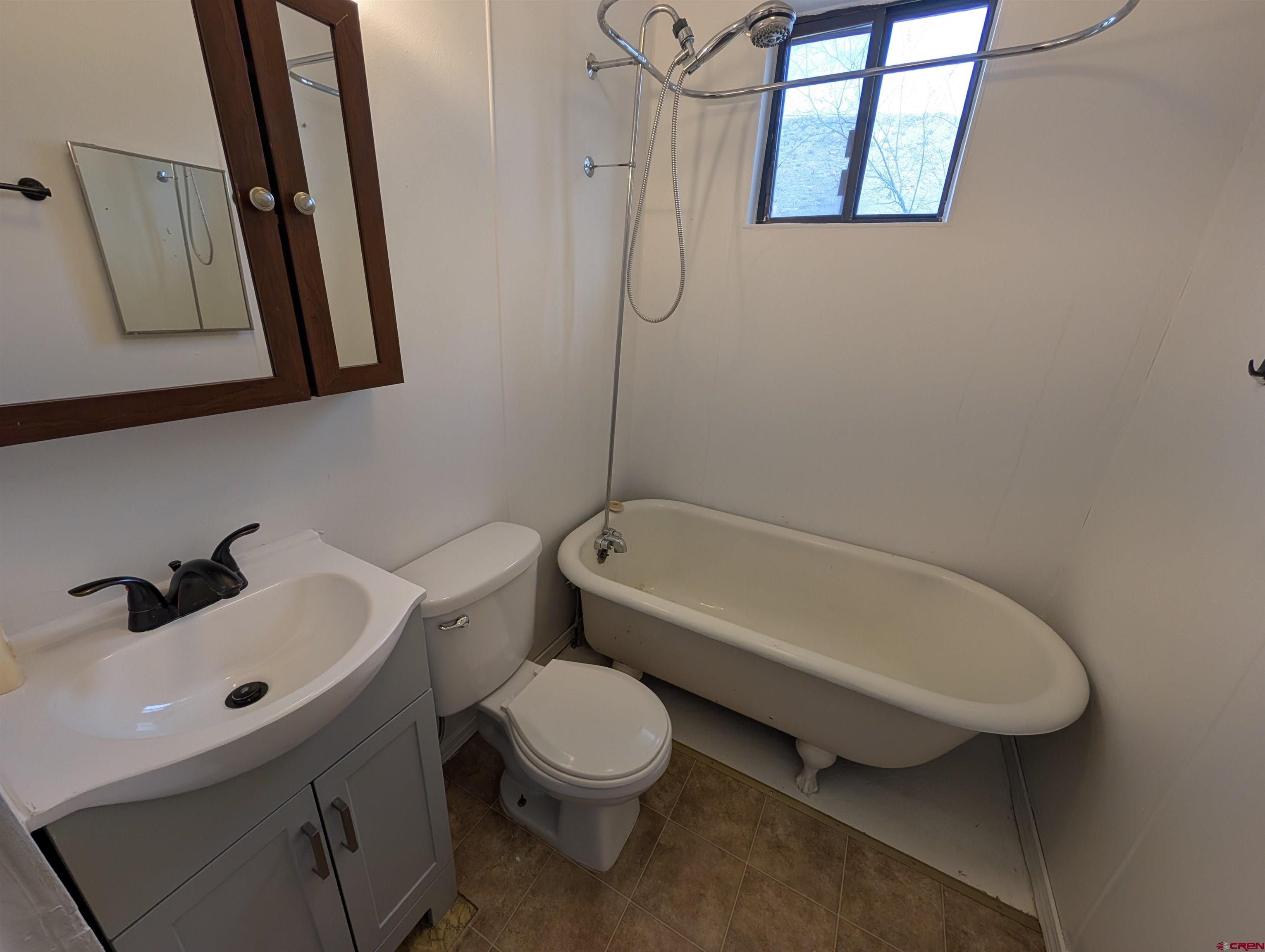 16184 Chipeta Road Montrose, CO 81403 - Photo 16 of 24 a bathroom with a sink mirror toilet and bathtub