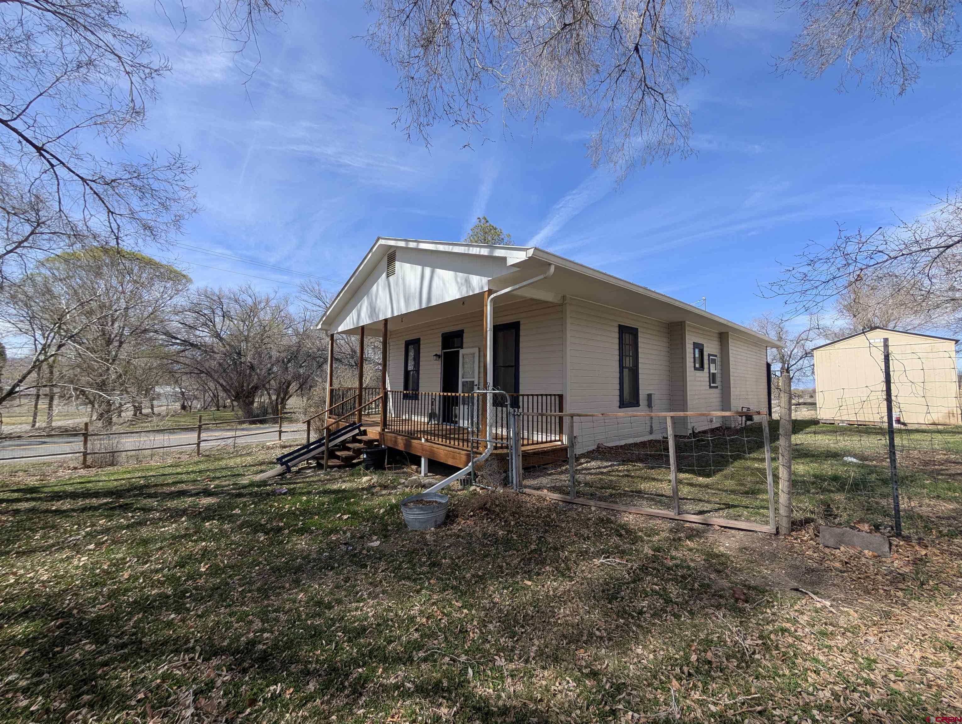 16184 Chipeta Road Montrose, CO 81403 - Photo 19 of 24 a view of a house with backyard porch and sitting area