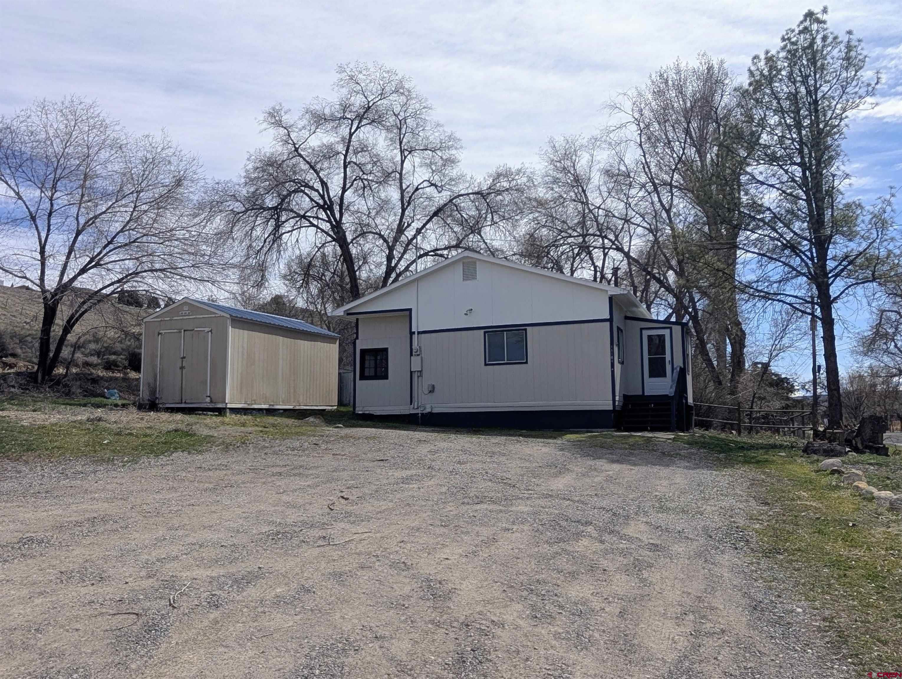 16184 Chipeta Road Montrose, CO 81403 - Photo 23 of 24 a house that has a tree in front of it