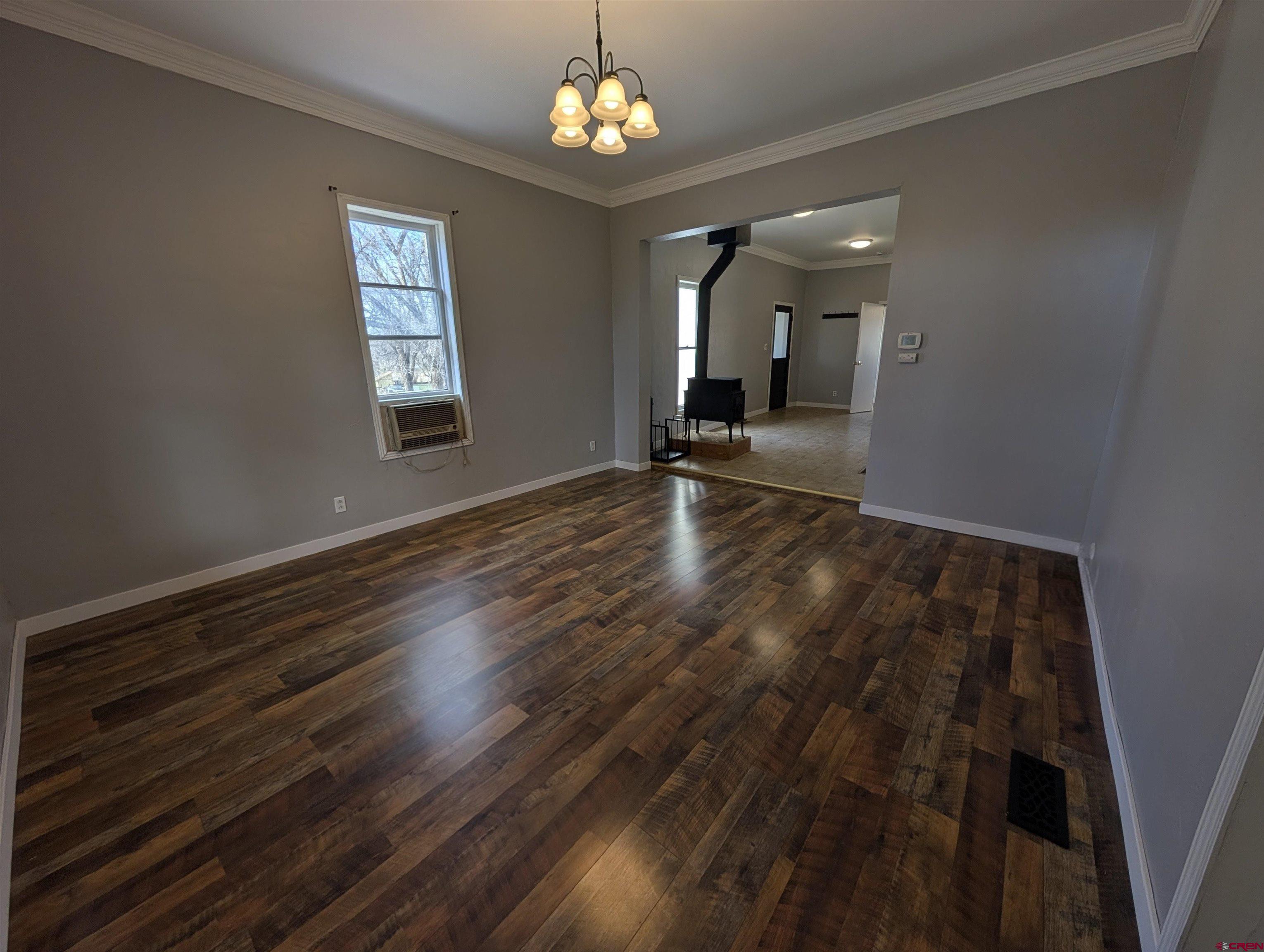 16184 Chipeta Road Montrose, CO 81403 - Photo 3 of 24 wooden floor in an empty room with a window