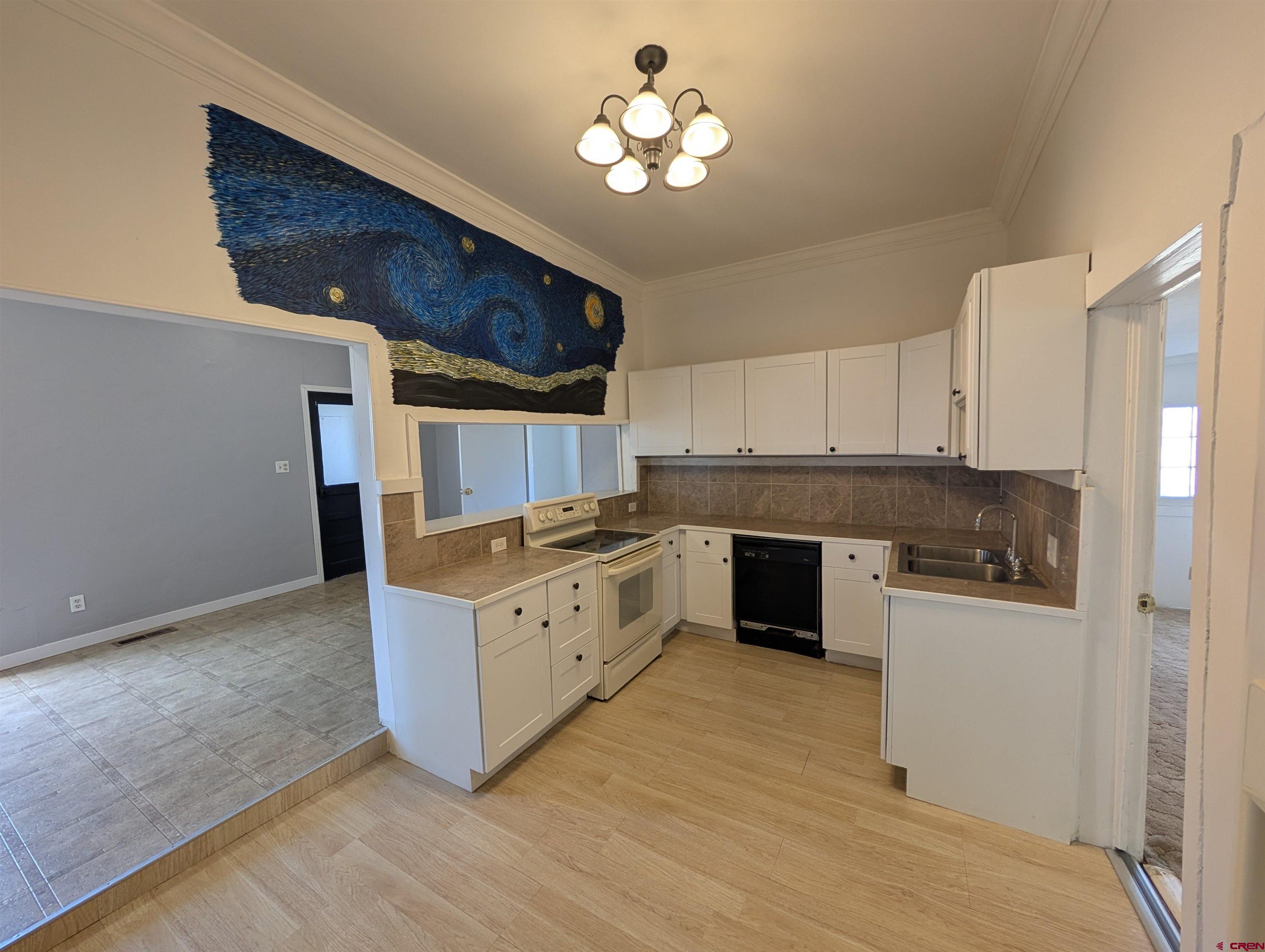 16184 Chipeta Road Montrose, CO 81403 - Photo 7 of 24 a kitchen with granite countertop a stove top oven and cabinets