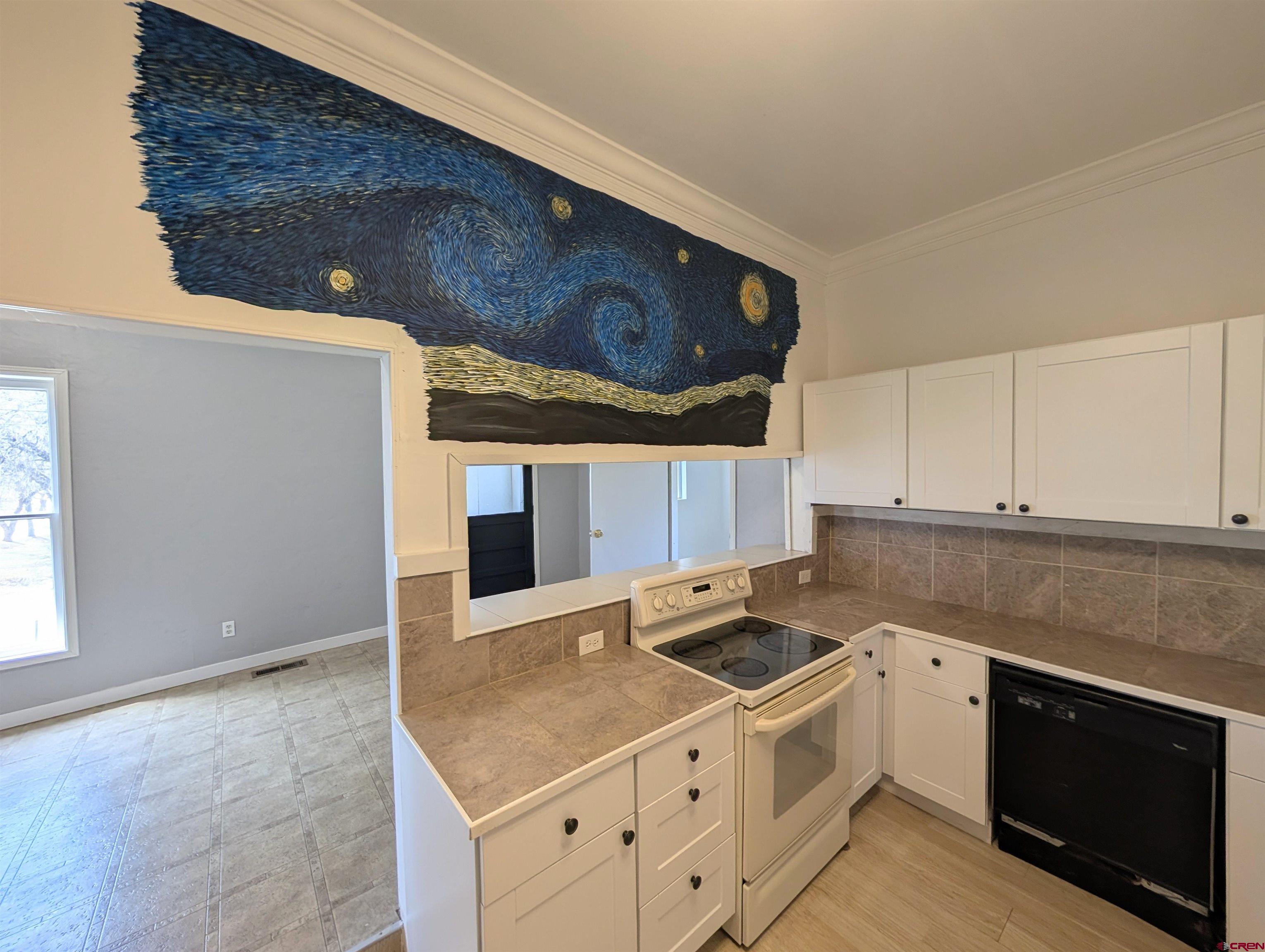 16184 Chipeta Road Montrose, CO 81403 - Photo 8 of 24 a kitchen with stainless steel appliances granite countertop a sink stove and cabinets