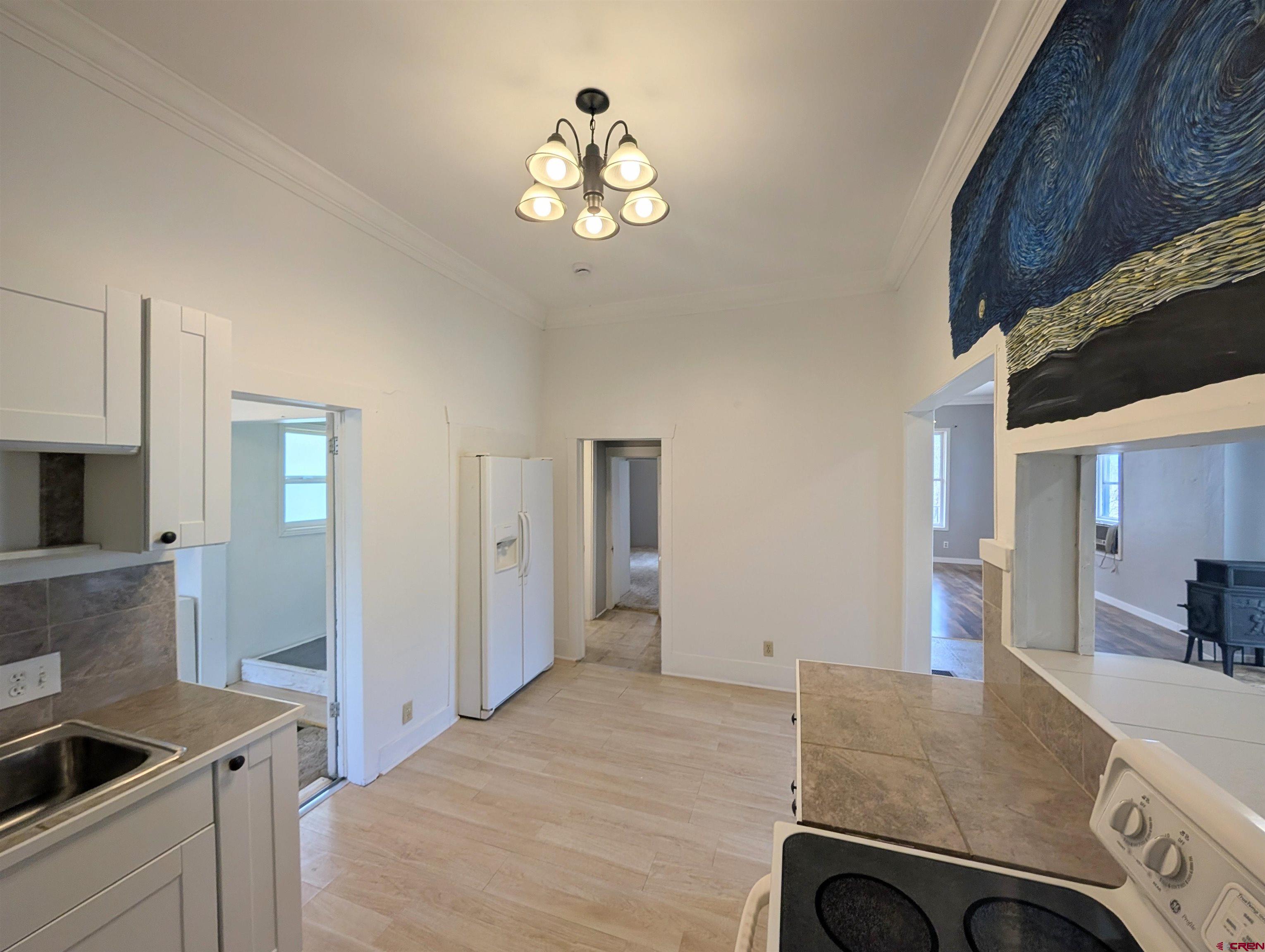 16184 Chipeta Road Montrose, CO 81403 - Photo 9 of 24 a bedroom with a bed and a chandelier