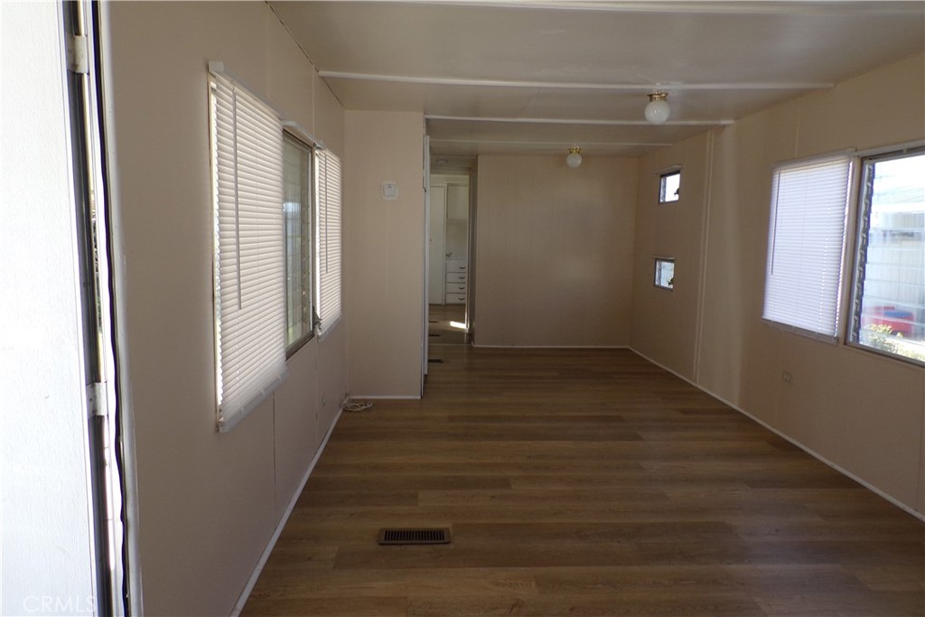 12710 3rd Street, Unit 36 Yucaipa, CA 92399 - Photo 8 of 10 a view of a livingroom with wooden floor and stairs