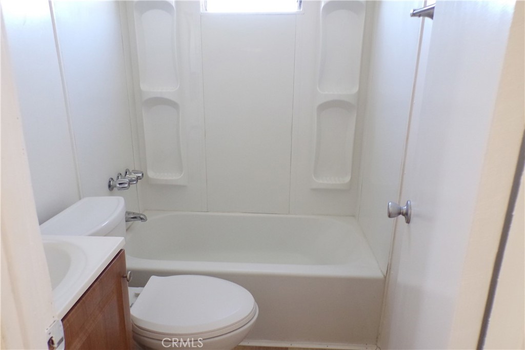 12710 3rd Street, Unit 36 Yucaipa, CA 92399 - Photo 10 of 10 a white toilet sitting next to a bath tub