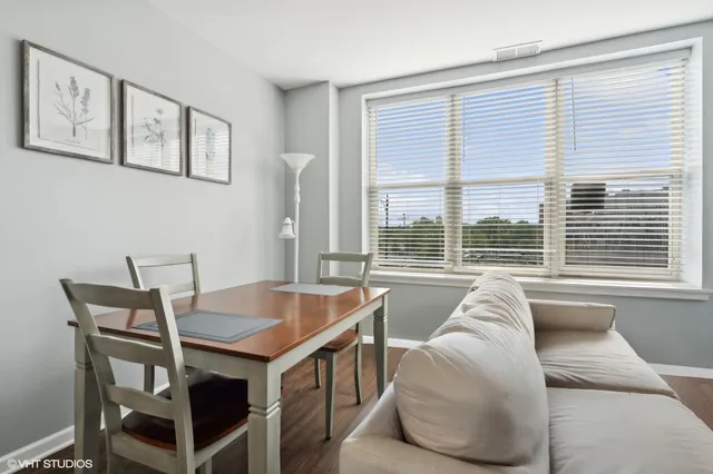 a living room with a large window and a table