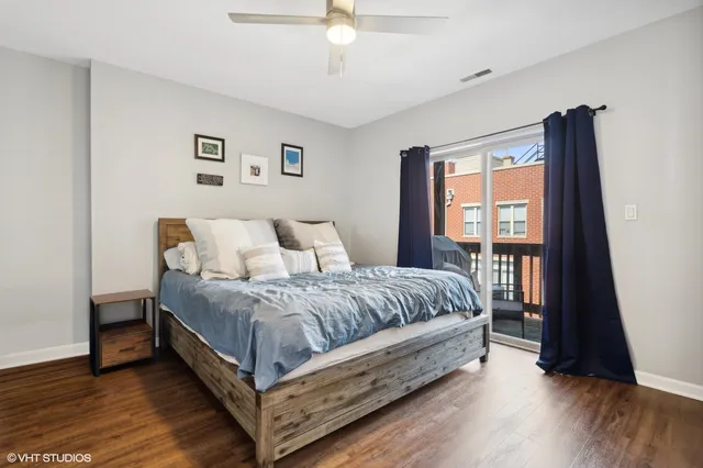 a bedroom with a bed lamp and a large window
