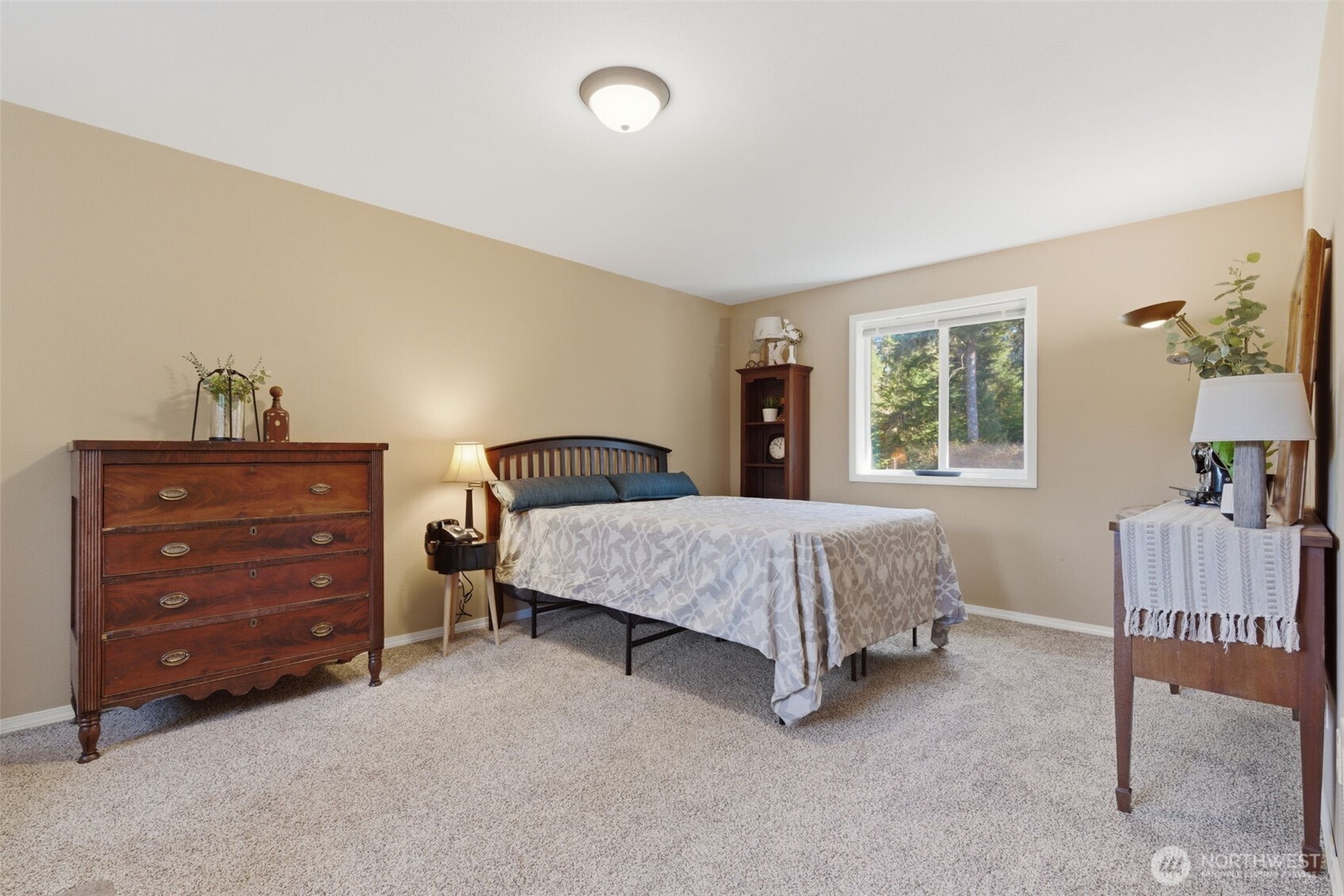 6971 Northeast Tahuya Blacksmith Road Belfair, WA 98528 - Photo 26 of 38 a bedroom with a bed and a dresser